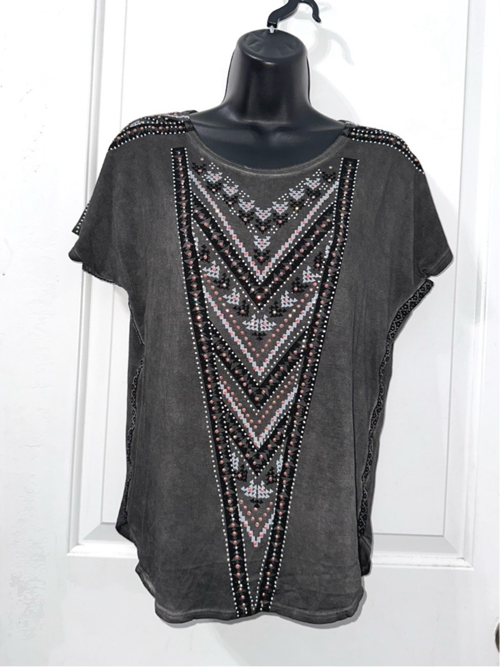 Vocal charcoal grey top, intricate geometric V-shaped design made of rhinestones
